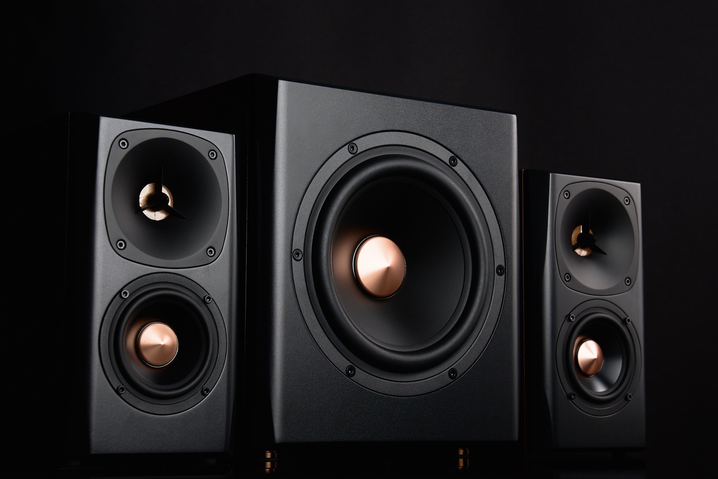 Two sound speakers and subwoofer on dark background